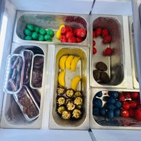 Tubs of colorful gummy candy and chocolates