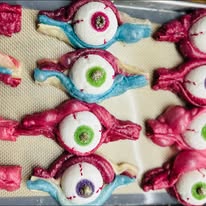 Halloween cookies iced pink, blue, and white to look like eyeballs