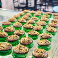 Pistachio macarons in a shop case