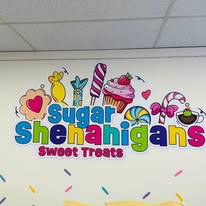 Colorful Sugar Shenanigans Sweet Treats logo painted on the shop wall